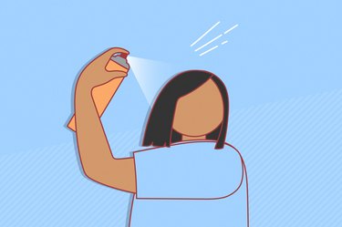 illustration of a person with shoulder-length black hair spraying dry shampoo onto their head, on a light blue background