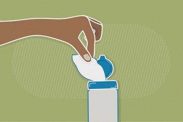 illustration of hand pulling disinfectant wipe from container with green background
