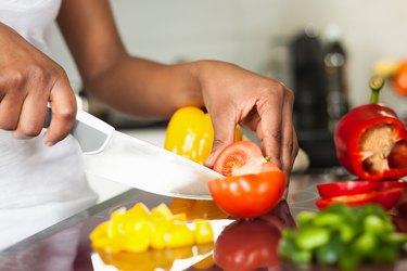 A person on Weight Watchers slicing up vegetables for dinner