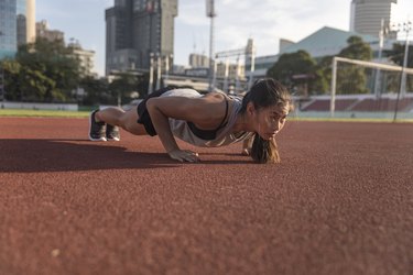 Adult performing push-ups outside